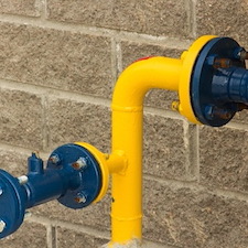 Gas line technician installing residential gas connection